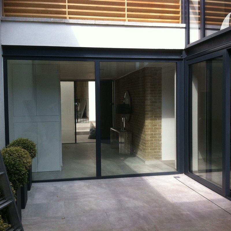 Floor-to-ceiling sliding doors opening to courtyard in Dunstable