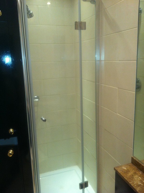 Frameless glass shower enclosure with chrome fittings in Dunstable