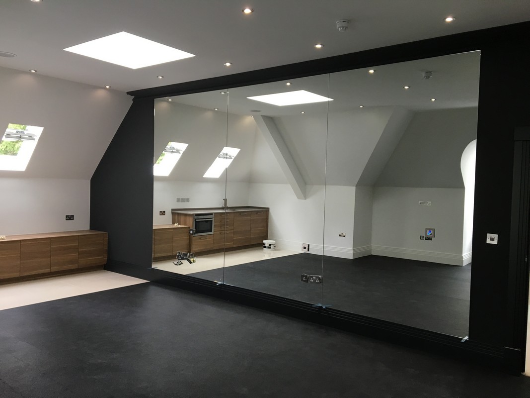 Frameless glass wall dividing loft conversion in Dunstable